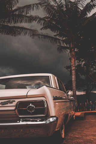 Classic Beauty Under Stormy Skies 🌩️🚗