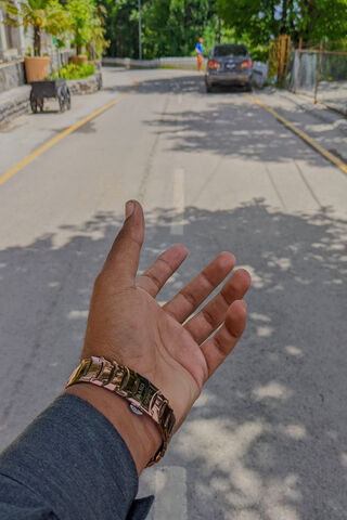A Hand Reaching Out on a Sunny Street 🌞✋