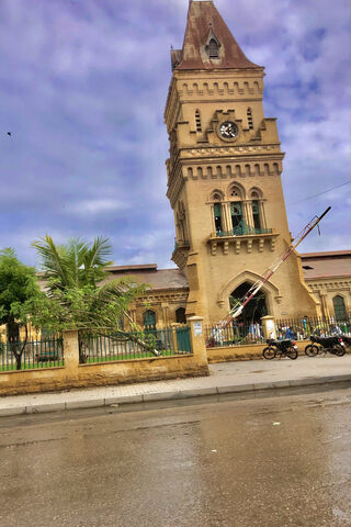 Majestic Clock Tower Under a Cloudy Sky 🌥️🕰️