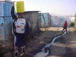 Woman carrying water -Soweto