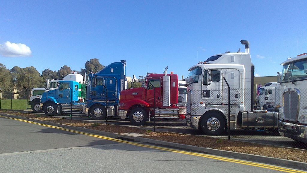 c509, t609 daycab, k200, t404 sar and k200 lined up at Kenworth factory